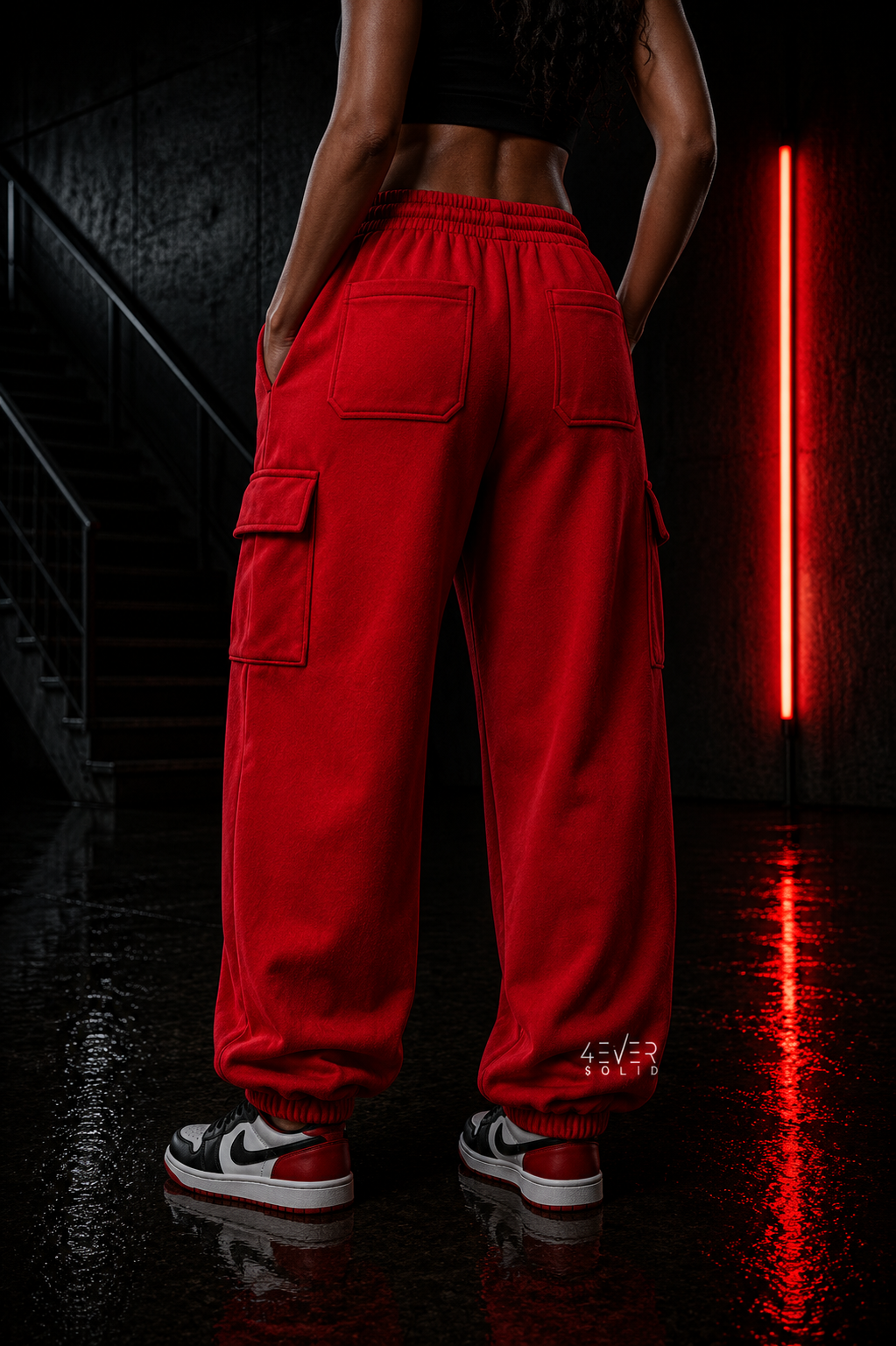 3VER 0LID RED Streetwear Joggers showcased on a model in a stylized urban setting with neon lighting.