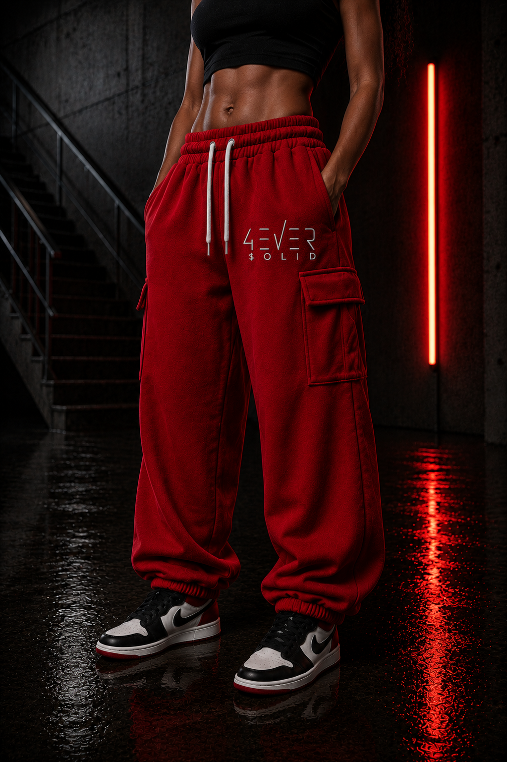 3VER 0LID RED Streetwear Joggers showcased on a model in an urban setting with neon lights.
